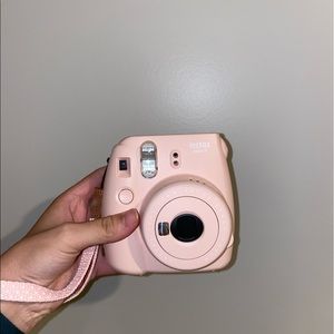 light pink polaroid camera